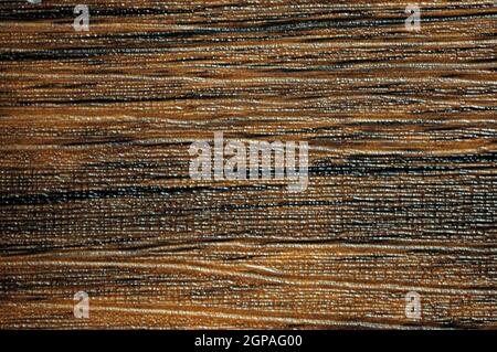 Dark walnut, flat surface of natural brown wood with small light stripes and traces of rough processing. Background, pattern, texture. Stock Photo