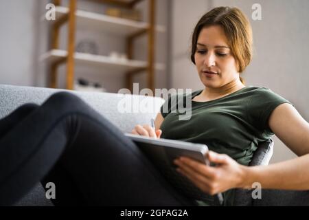 Designer Hand Drawing On Convertible Laptop Computer Stock Photo