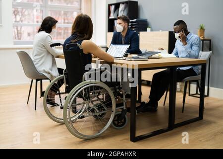 Diverse Disabled Business Worker People In Wheelchair Wearing Face Mask Stock Photo