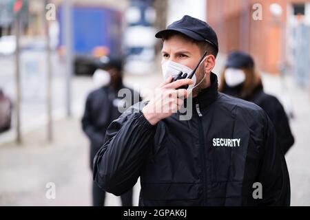 Security Officer Staff Or Bodyguard Protection In Face Mask Stock Photo