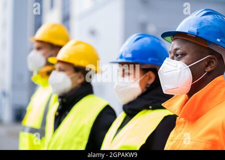 Factory Engineers Or Construction Workers In Face Mask Stock Photo