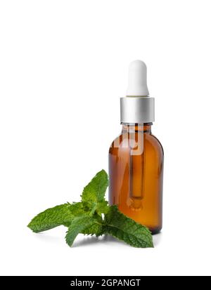 Cosmetic dropper bottle with fresh mint on white background Stock Photo