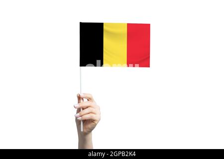 Beautiful female hand holding Belgium flag, isolated on white background. Stock Photo