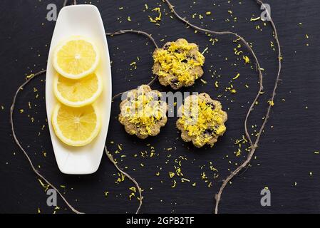 lemon cupcakes on a black background with lemon zest Stock Photo
