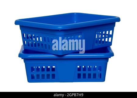 Empty basket isolated. Two empty blue rectangular stacked plastic laundry baskets isolated on a white background. Household equipment. Clipping path. Stock Photo