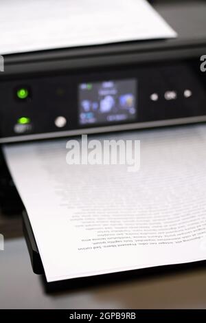 Printed paper with lorem ipsum text in modern inkjet printer. Stock Photo