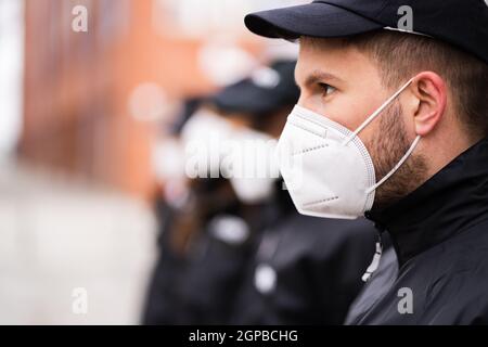 Security Officer Staff Or Bodyguard Protection In Face Mask Stock Photo