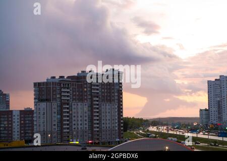 Arcus cloud or shelf cloud of a massive storm rolling over town, evening Stock Photo