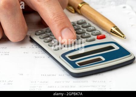 Close up on accountant hand pressing on calculator for calculate monthly incomes , business concept Stock Photo