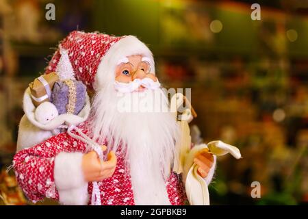 Close-up of santa claus doll, santa claus statue with christmas decorations and gifts. Winter holidays concept Stock Photo