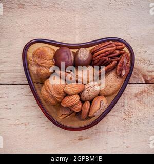 Selection food sources of omega 3 and unsaturated fats. Super food high vitamin e and dietary fiber for healthy food. Almond ,pecan ,hazelnuts and wal Stock Photo