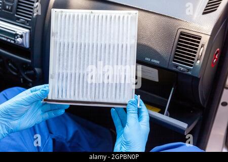 Replacing the cabin pollen air filter for a car Stock Photo - Alamy