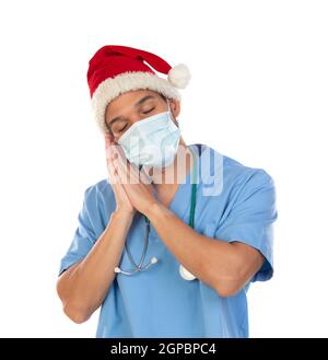 African doctor wearing a Christmas hat at coronavirus time isolated on a white background Stock Photo