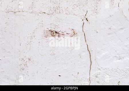 Surface of a wall with worn paint and cracks Stock Photo