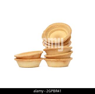 stack of empty baked round canape baskets isolated on white background, close up Stock Photo
