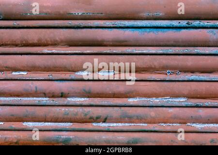 Old burgundy metal door close to use as wallpaper Stock Photo