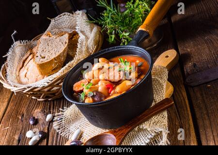 Delicious bean stew with sausage and potato Stock Photo