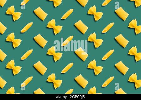 Italian pasta pattern on a green background. Top view. Stock Photo