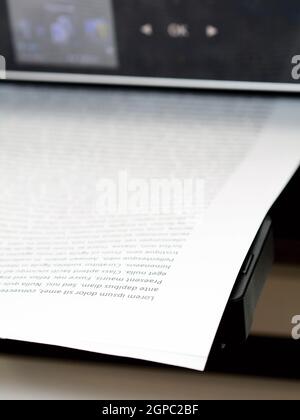 Printed paper with lorem ipsum text in modern inkjet printer. Stock Photo