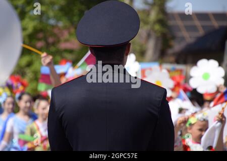 Slavyansk-on-Kuban, Russia - May 1, 2018: A policeman, who cries out the tranquility of citizens at a festive procession. Celebrating the first of May Stock Photo