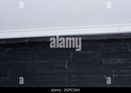 Wall with black bricks or straps tiles. Stock Photo