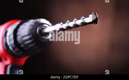 Composition with a cordless drill also working as a screw gun Stock Photo