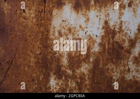 old rusty iron sheet covered with brown rust and grey paint. Background and wallpaper picture. Corrosion. Ecological pollution concept. Reconstruction Stock Photo