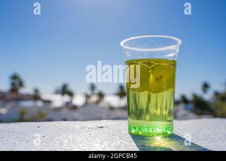 beach glass cup with blue top and blue straw on white table with gray white  background Stock Photo - Alamy