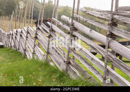 Traditional hand made roundpole fence in Uvdal, Norway Stock Photo