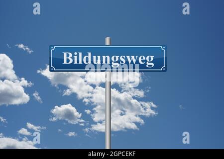 German word educational path on road sign in front of sky education school learning Stock Photo