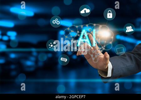 Businessman hand touching virtual brain icon. A.I. The use of operating systems to help verify research with modern computer systems. Stock Photo