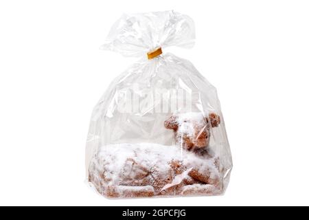 Easter decoration element. Close-up of a traditional Easter lamb cake in a transparent foil or cellophane bag wrapped isolated on a white background. Stock Photo