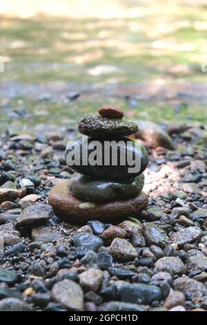 Pyramid of stones in the Japanese style on the river bank. Meditation. Relax.  Stock Photo