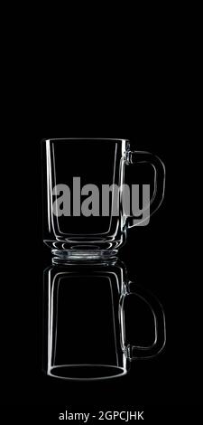 Just a glass on a black background with a reflection. Isolated. Stock Photo