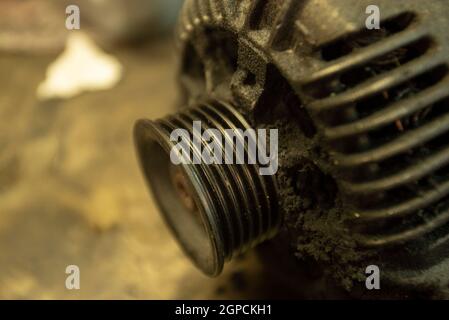Old worn alternator of the car to be replaced Stock Photo