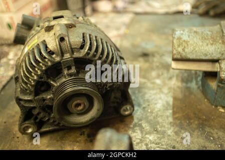 Old worn alternator of the car to be replaced Stock Photo