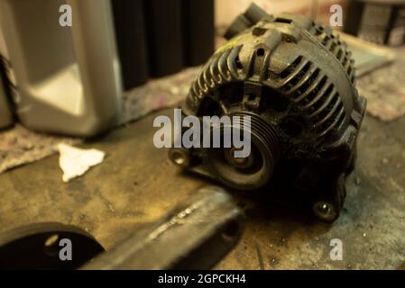 Old worn alternator of the car to be replaced Stock Photo