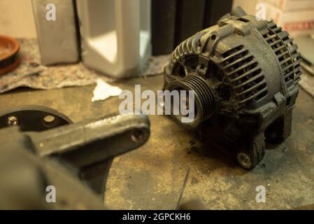 Old worn alternator of the car to be replaced Stock Photo