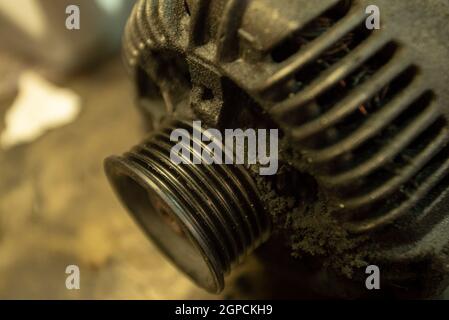 Old worn alternator of the car to be replaced Stock Photo