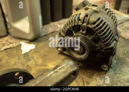 Old worn alternator of the car to be replaced Stock Photo