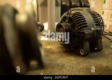 Old worn alternator of the car to be replaced Stock Photo