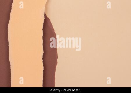 Torn grunge ripped beige brown geometric paper background. Colorful torn paper collage wallpaper Stock Photo