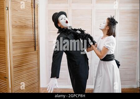 Two mime artists, love couple parody. Pantomime theater, comedian, positive emotion, humour performance, funny face mimic and grimace Stock Photo