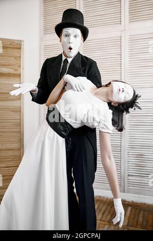 Two mime artists, parody, comedy performance. Pantomime theater, comedian, positive emotion, humour performance, funny face mimic and grimace Stock Photo