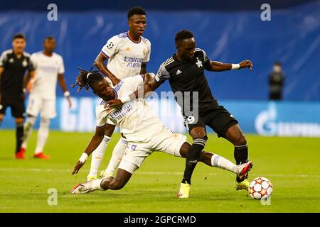 Madrid, Spain. 28th Sep, 2021. Real Madrid's Eduardo Camavinga (L, front) vies with Sheriff's Adama Traore (R) during the UEFA Champions League Group D match between Real Madrid CF and FC Sheriff Tiraspol in Madrid, Spain, Sept. 28, 2021. Credit: Edward F. Peters/Xinhua/Alamy Live News Stock Photo