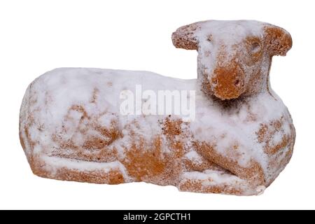 Easter decorations isolated. Macro of a traditional german easter lamb cake with powdered sugar or icing sugar isolated on a white background. Religio Stock Photo