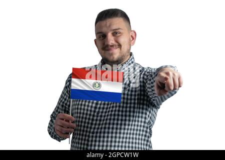 White guy holding a flag of Paraguay and points forward in front of him isolated on a white background. Stock Photo