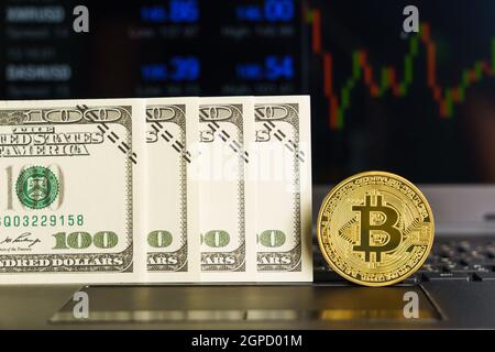 Bitcoins coin and banknotes on keyboard computer. Close up of  bitcoin crypto currency coins with trading exchange market price chart in the backgroun Stock Photo