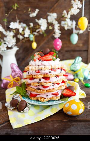 Waffles stacked with whipped cream and fresh strawberries Stock Photo