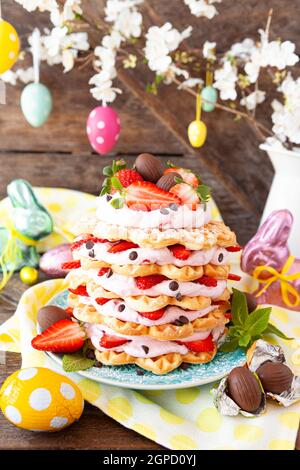 Waffles stacked with whipped cream and fresh strawberries Stock Photo